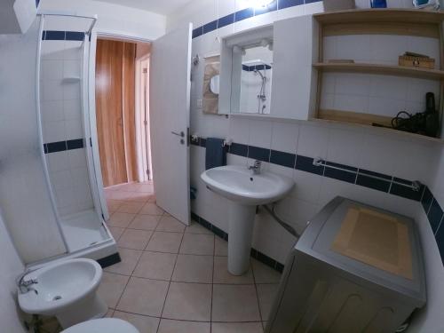 een badkamer met een wastafel, een toilet en een douche bij Leme Bedje fronte spiaggia in Santa Maria