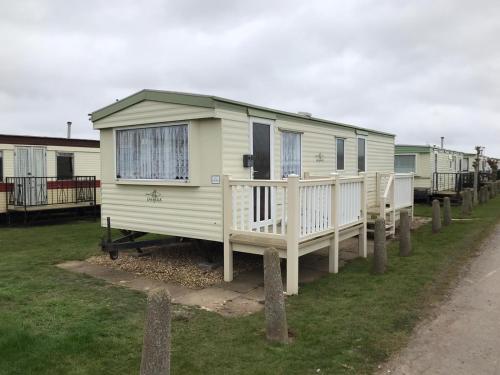 a row of mobile homes parked in a field at 6 Berth Golden Sands Ingoldmells Sahara in Ingoldmells