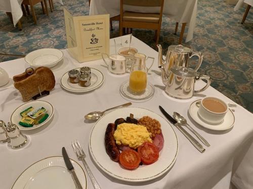 a table with a plate of breakfast food on it at Saxonville Hotel in Whitby