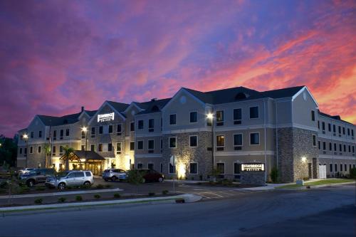 a large building with cars parked in a parking lot at Staybridge Suites North Jacksonville by IHG in Jacksonville