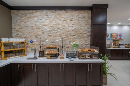 a bakery with a counter and a brick wall at Staybridge Suites Houston East - Baytown by IHG in Baytown