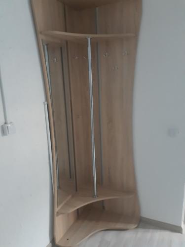 a wooden cabinet in a corner of a room at Жилье отдельное in Odesa