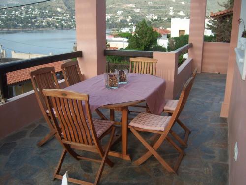 a table and chairs on a balcony with a view at Calma in Perdika