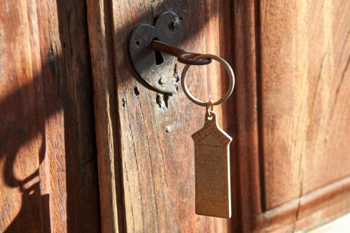 a wooden door with a tag hanging on it at El Molino Estepona in Estepona