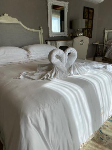 a white bed with a pair of towels on it at Lulu Boutique Hotel in Żebbuġ