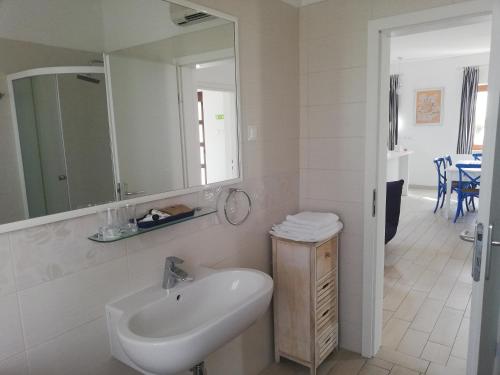 a white bathroom with a sink and a mirror at Apartment Jujube-IQM Destination Quality in Mali Lošinj