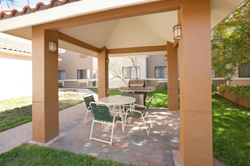 a pergola with a table and chairs on a patio at Staybridge Suites Lubbock-University Area, an IHG Hotel in Lubbock