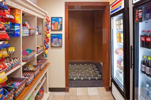 a aisle of a store with a door and food at Staybridge Suites Lubbock-University Area by IHG in Lubbock