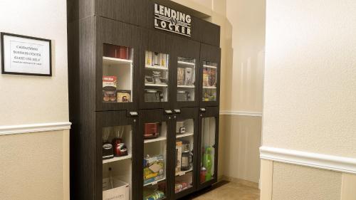a book shelf in a hallway with a book shelfigunigunigunigunigunigun at Candlewood Suites Saint Joseph - Benton Harbor by IHG in Stevensville