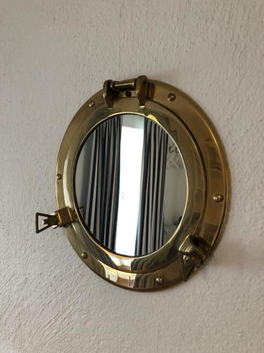 a round mirror hanging on a ceiling at Glimminge Bed & Breakfast in Simrishamn