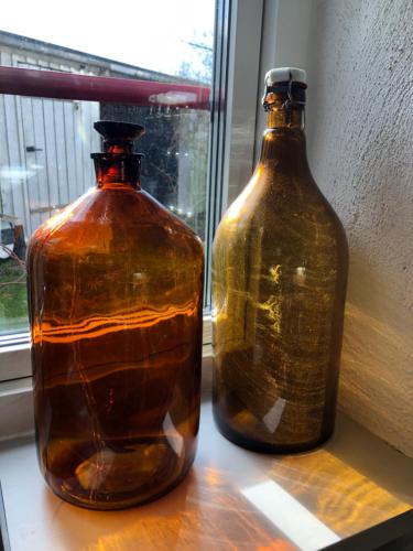 two large glass bottles sitting on a window sill at Glimminge Bed & Breakfast in Simrishamn