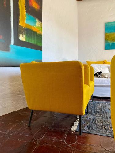 a yellow couch in a room with a bed at El Molino Estepona in Estepona