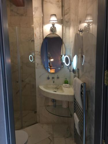 a bathroom with a shower and a sink and a mirror at Lulu Boutique Hotel in Żebbuġ