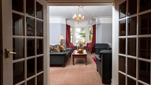 a living room with a couch and a table at Kiltearn Guest House in Evanton