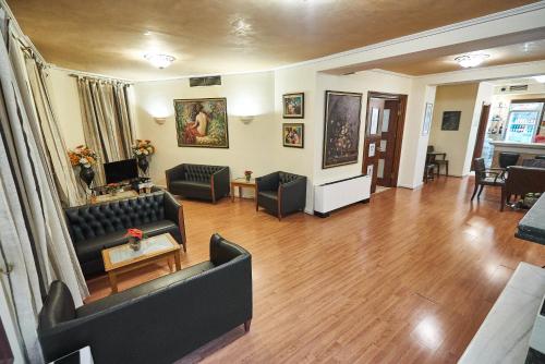 a living room with a couch and a table at Exis Hotel in Athens