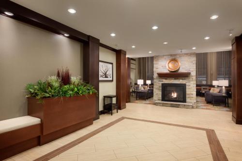 a lobby of a hotel with a fireplace at Staybridge Suites Midland by IHG in Midland