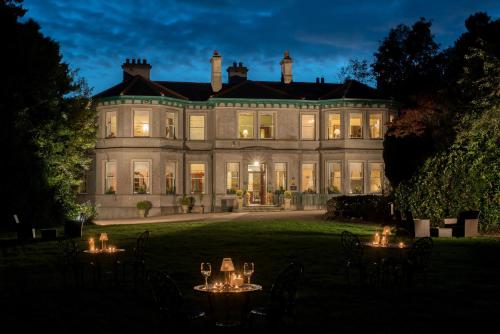 a large house with tables in front of it at Ardtara Country House in Upperlands