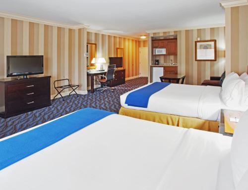 a hotel room with two beds and a flat screen tv at Holiday Inn Express Hotel & Suites Santa Cruz by IHG in Santa Cruz
