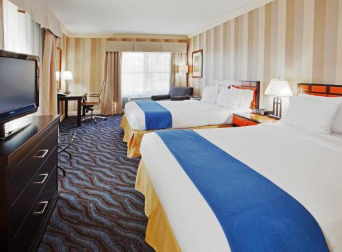 a hotel room with two beds and a flat screen tv at Holiday Inn Express Hotel & Suites Santa Cruz by IHG in Santa Cruz