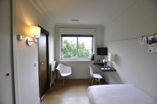 a hotel room with a bed and a window at Hotel Rio Bidasoa in Hondarribia
