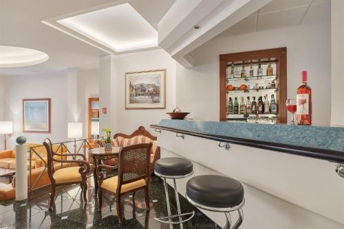 a bar with chairs and a table with wine bottles at Athos Hotel in Athens