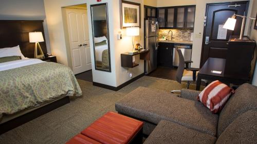a hotel room with a bed and a couch at Staybridge Suites Lexington by IHG in Lexington
