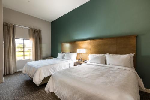 a hotel room with two beds and a window at Staybridge Suites - Lake Jackson by IHG in Lake Jackson