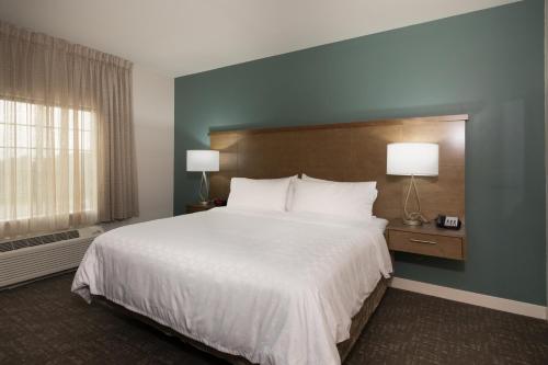 a bedroom with a large white bed and a window at Staybridge Suites - Lake Jackson by IHG in Lake Jackson