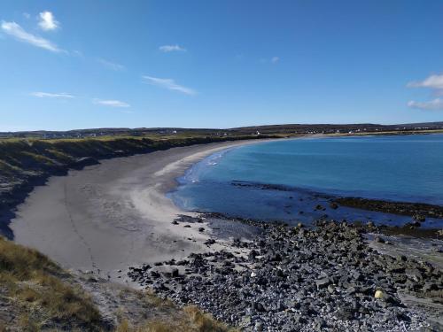 a view of a beach with rocks and water at Tigh Fitz Apartments - Inis Mór, Aran Island in Inis Mor