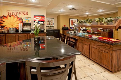 a restaurant with a bar with a coffee counter at Staybridge Suites McAllen by IHG in McAllen