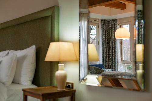 a bedroom with a mirror and a bed and a lamp at Vazisubani Estate in Vazisubani