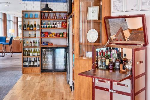 a bar in a room with bottles of wine at Staybridge Suites Liverpool by IHG in Liverpool