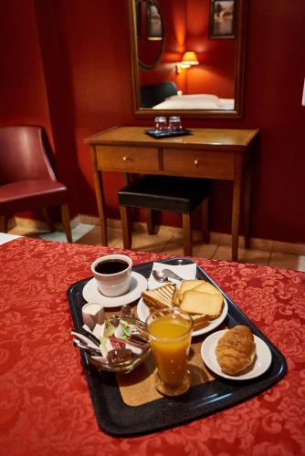 a tray of breakfast food on a table with a mirror at Exis Hotel in Athens