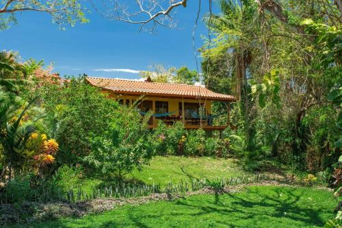 a house in the middle of a garden at Anamaya Resort in Montezuma