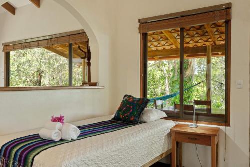 a bedroom with a bed with towels on it at Anamaya Resort in Montezuma