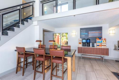 a dining room with a table and chairs at Holiday Inn Express Hotel & Suites Bradenton West by IHG in Bradenton