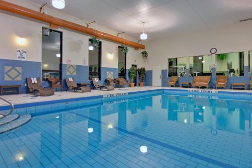 a large swimming pool in a hotel with chairs at Holiday Inn Express Hotel & Suites Charlottetown, an IHG Hotel in Charlottetown