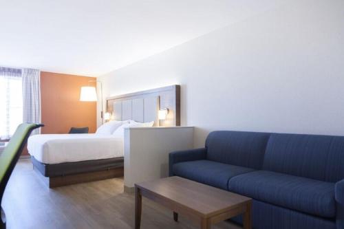 a hotel room with a bed and a couch at Holiday Inn Express Hotel & Suites Charlottetown by IHG in Charlottetown