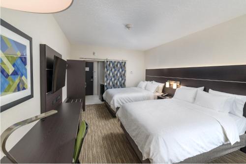 a hotel room with two beds and a flat screen tv at Holiday Inn Express & Suites - Saskatoon East - University by IHG in Saskatoon