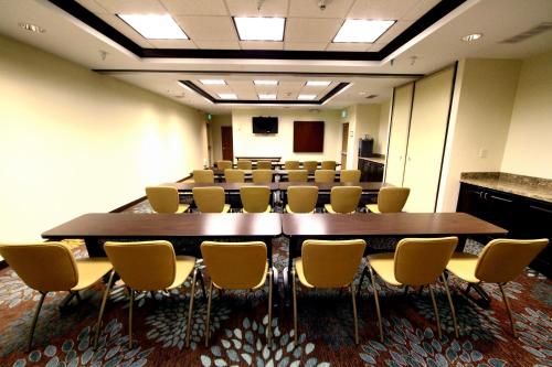 マイノットにあるStaybridge Suites Minot by IHGの大きなテーブルと椅子のある会議室