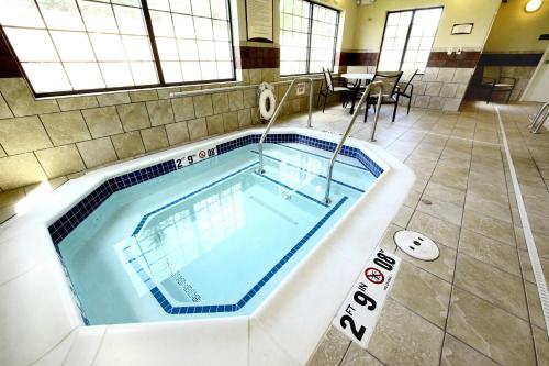 
a swimming pool with a large tub in the middle of it at Staybridge Suites Minot, an IHG Hotel in Minot
