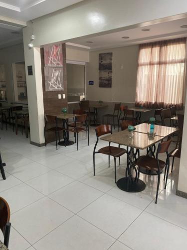 a dining room with tables and chairs in it at Hotel Aquarius in Fortaleza