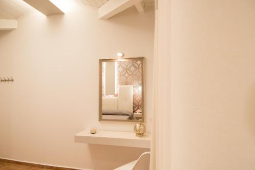 a bathroom with a mirror on the wall at Paradise Vezal in Laganas