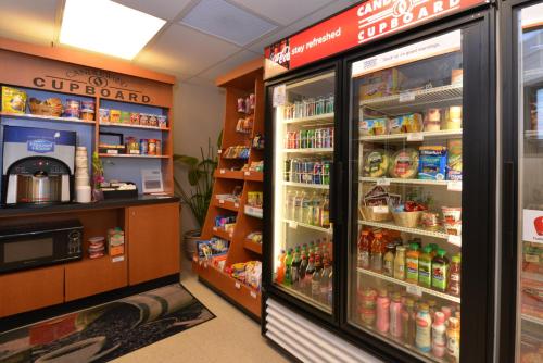 a store aisle with a refrigerator and shelves of food at Candlewood Suites Boise - Towne Square by IHG in Boise