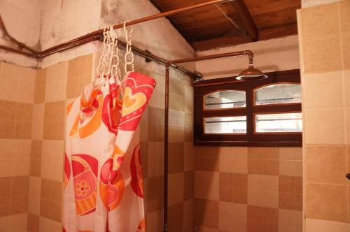 a shower curtain in a bathroom with a window at Hospedaje Rural Misia Emilia in Medellín