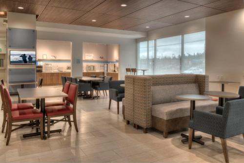 a dining room with tables and chairs and tablesktop at Holiday Inn Express & Suites Victoria-Colwood by IHG in Victoria