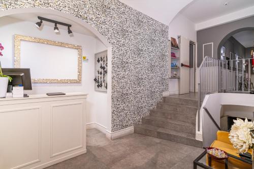 a room with a stone wall and a marble floor at Dedo Boutique Hotel in Florence