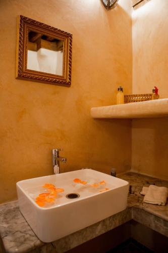 a white sink in a bathroom with a mirror at Dar Settash in Fès