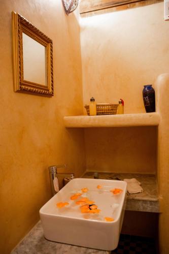 a bathroom with a sink and a mirror on the wall at Dar Settash in Fès