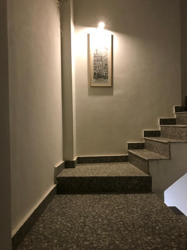 a stairway with a light and a picture on the wall at VIA VARANASI-A Boutique Hotel in Varanasi